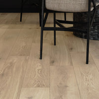 Wooden flooring with a chair and decorative item in the background