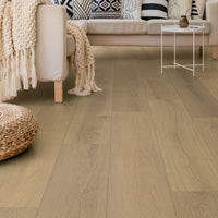 Living room with wooden flooring, sofa, and decorative items.