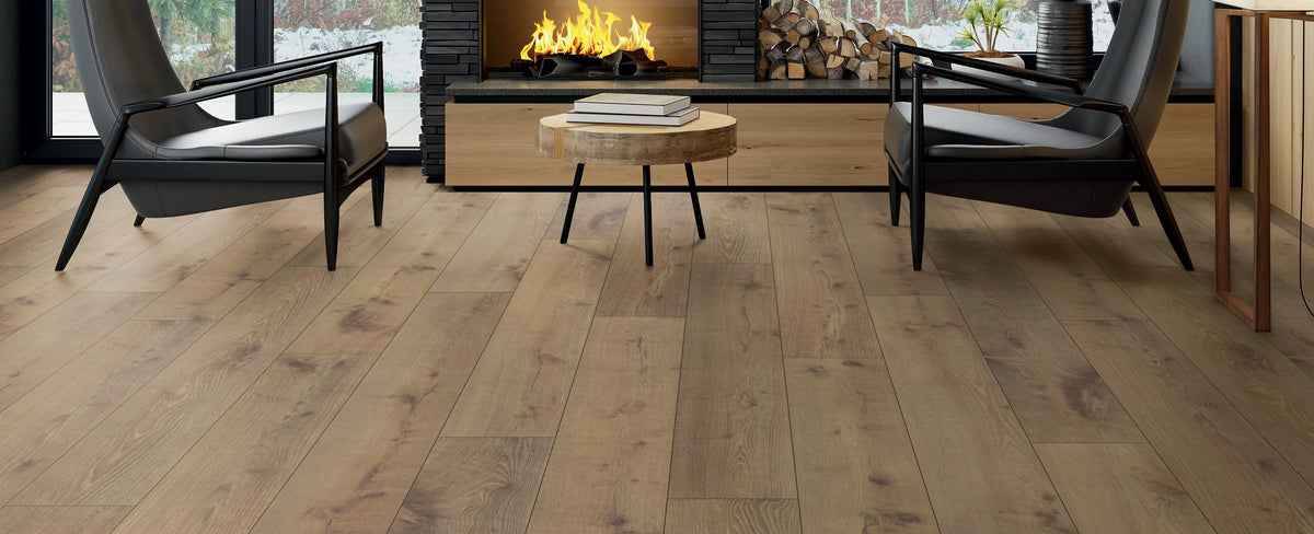 Wooden flooring with a modern living room setup featuring chairs and a fireplace.