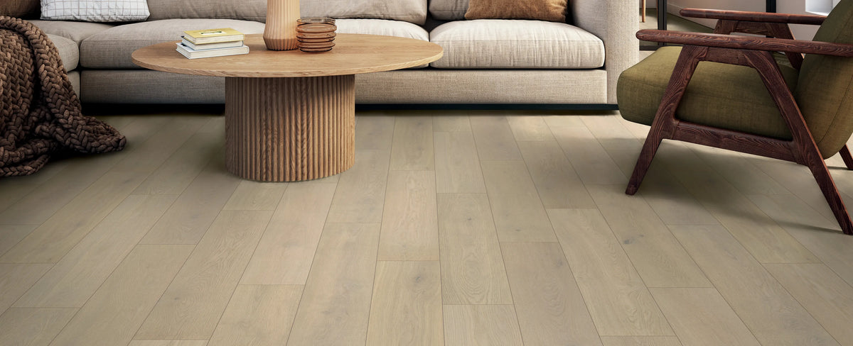 Living room with wooden flooring, sofa, and coffee table.
