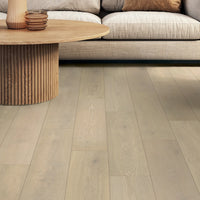 Living room with wooden flooring, sofa, and coffee table.