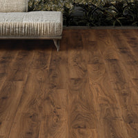 Wooden flooring in a living room setting with a sofa and coffee table.