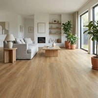 Modern living room with wooden flooring, gray sofa, and decorative elements.