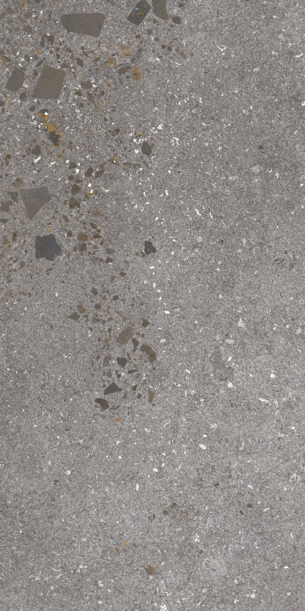 Close-up of a textured concrete surface with small stones and variations in gray tones.