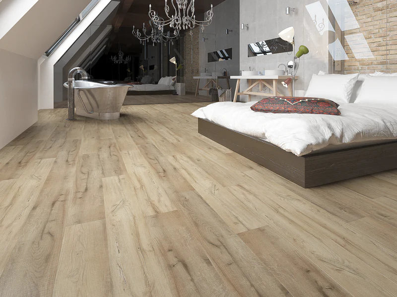 Modern bedroom with wooden flooring, bed, and bathroom.